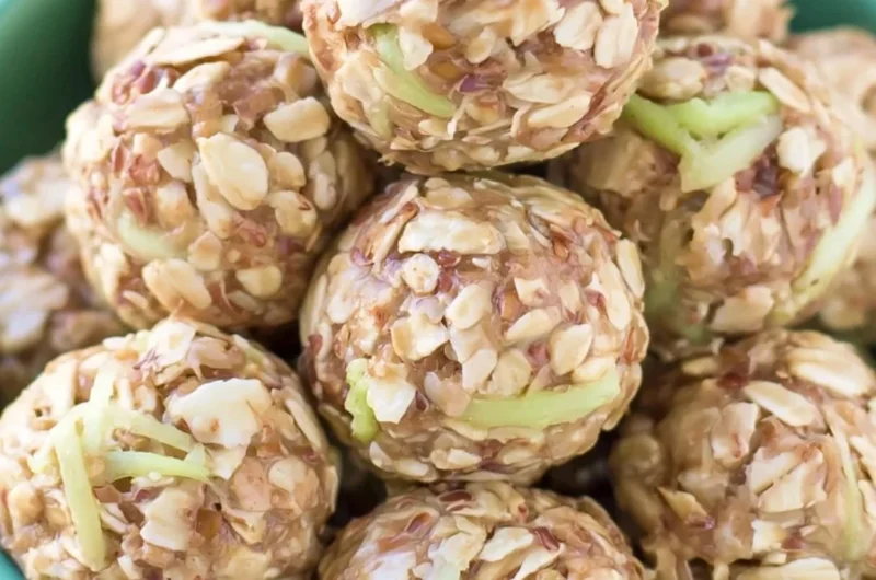 Apple Cinnamon Cookie Energy Bites displayed on a wooden surface.