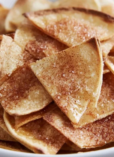 Cinnamon sugar tortilla chips stacked on a plate, ready to enjoy.