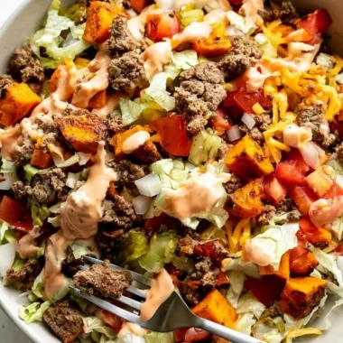 Colorful sweet potato burger bowl with fresh vegetables and toppings