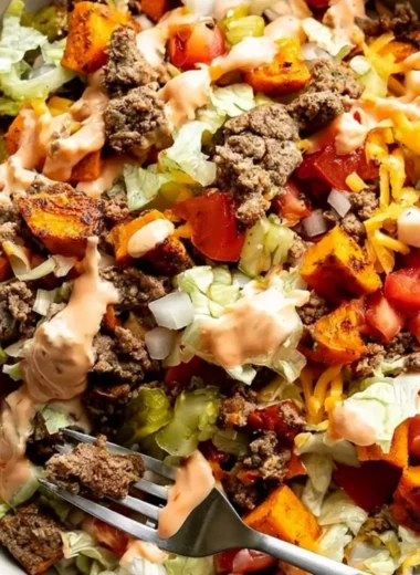 Colorful sweet potato burger bowl with fresh vegetables and toppings