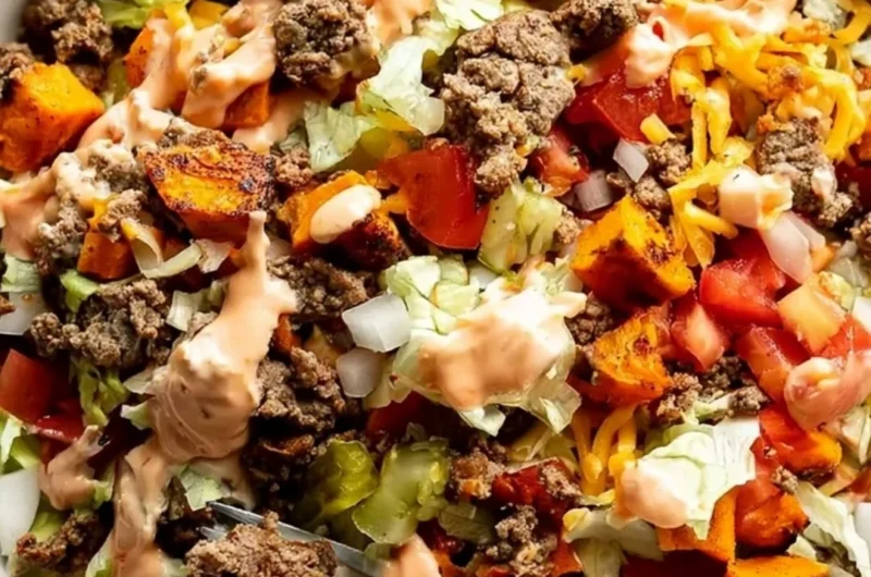 Colorful sweet potato burger bowl with fresh vegetables and toppings